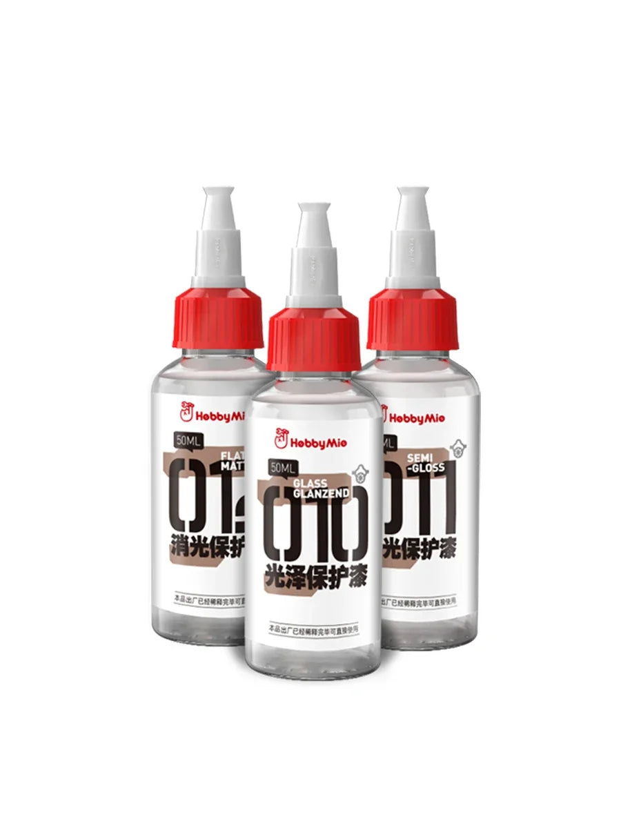 Three transparent glass bottles with red caps and white spray nozzles labeled hebbymie hobby mio 50ml pre-mixed varnishes for scale modeling tools