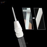 Carving tool with white handle and sharp triangular metal tip