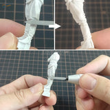 Carving tool detailing a white plastic figure