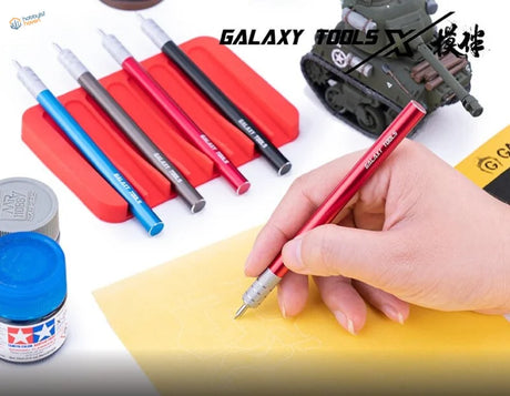 Red Galaxy 360 rotating blade pen held in hand with precision tool