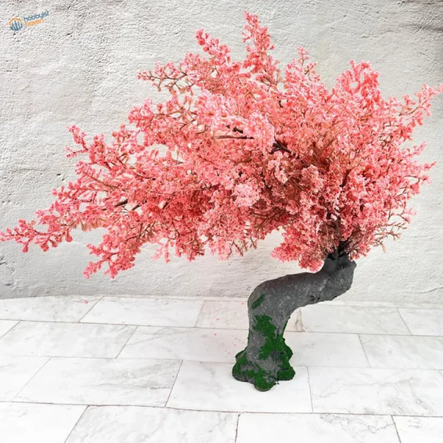 Vibrant handmade cherry tree with pink blossoms, dark trunk, green moss