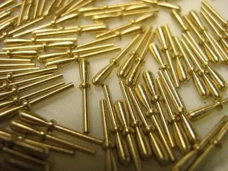 Golden metal pins with cylindrical bodies and rounded heads.