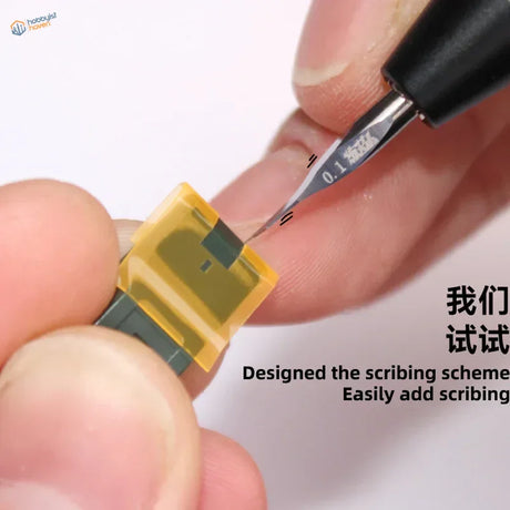 High precision scribing tape with yellow fuse and clip held in fingers