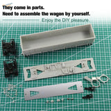 Gray plastic ho scale 1:87 high-side gondola wagon parts on green cutting mat with model building tools for assembly