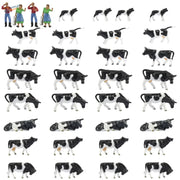 HO scale livestock farmers: black and white plastic cow figurines in various poses