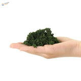 HO scale tree powder: dark green textured clay in open palm for railroad scenery