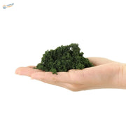 HO scale tree powder: dark green textured clay in open palm for railroad scenery