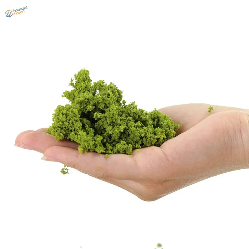 HO scale tree powder: vibrant green mound in open palm for railroad scenery