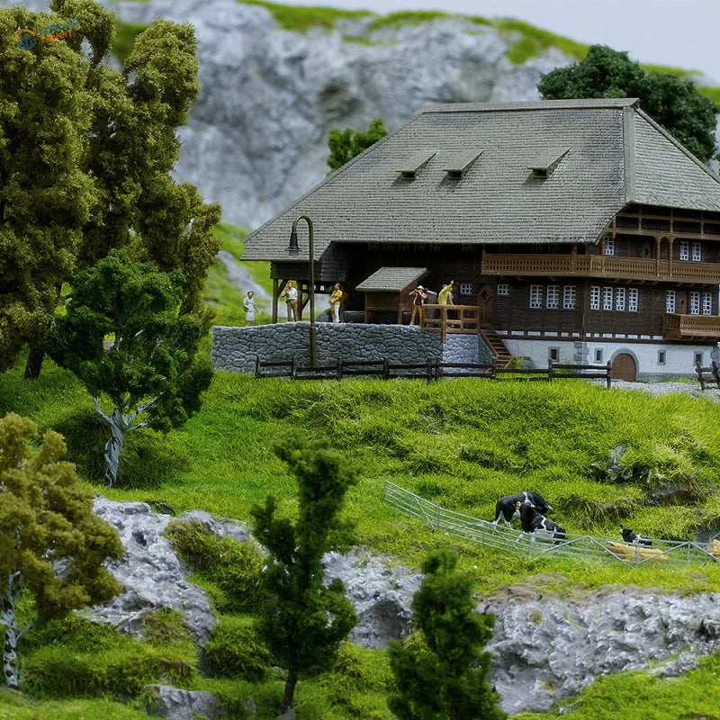 HO scale tree powder with detailed miniature wooden house, gray shingled roof, stone foundation, balconies, windows for railroad scenery
