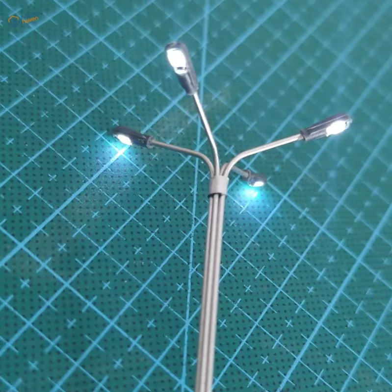 Miniature silver ho/tt scale led street lamp with three illuminated heads for model train layouts