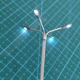 Miniature silver ho/tt scale led street lamp with three illuminated heads for model train layouts