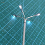 Miniature silver ho/tt scale led street lamp with three illuminated heads for model train layouts