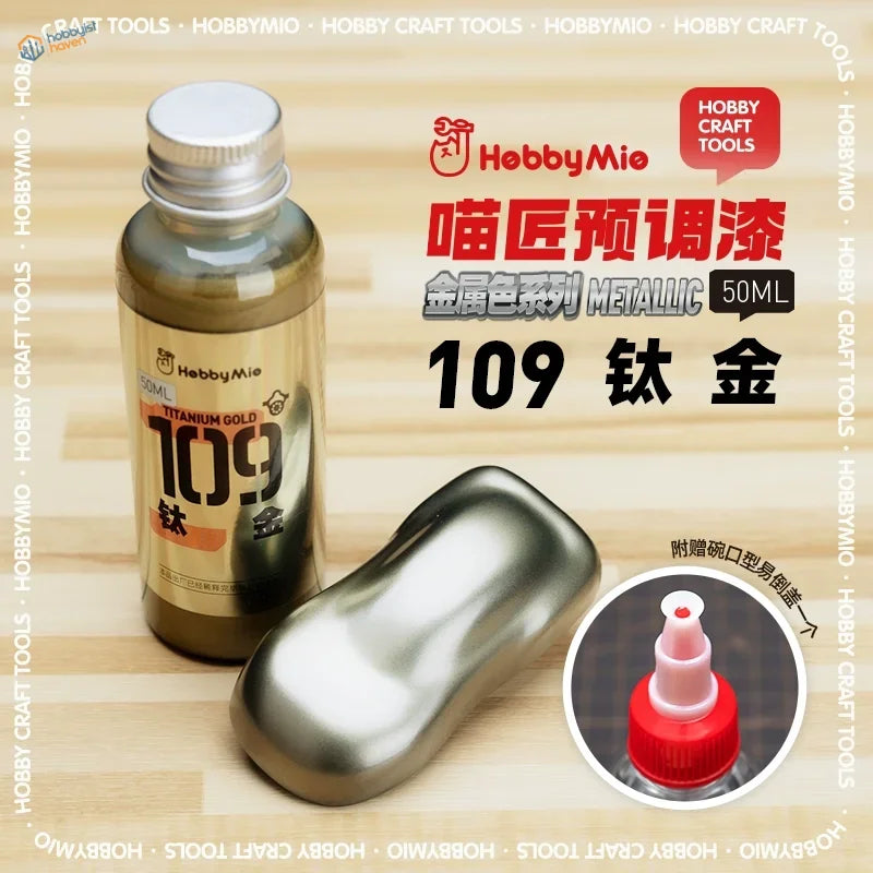A sleek metallic gold 50ml bottle of Hobby Mio oil-based paint ideal for scale modeling and precision hobby tools