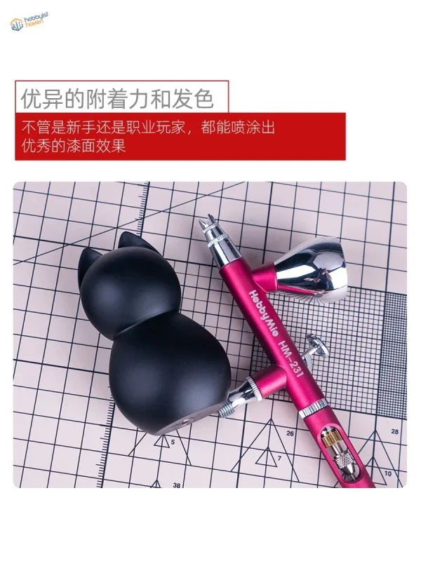 Pink and silver hobbymate hm-231 airbrush with a black cat-shaped paint cup for precision hobby tools in scale modeling