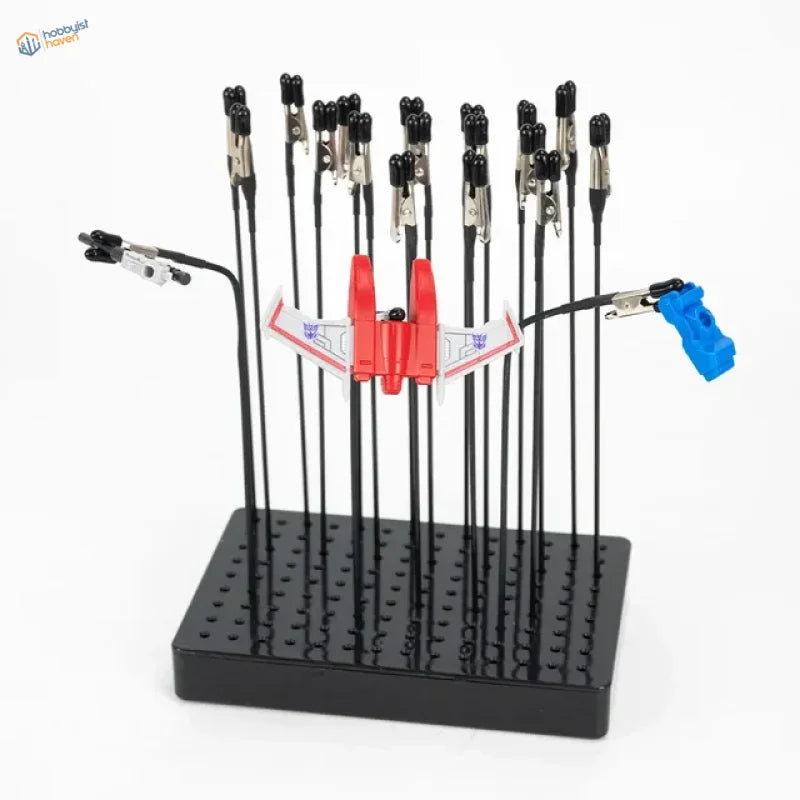 Holder with 20 magnetic alligator clips and red Transformers jet toy