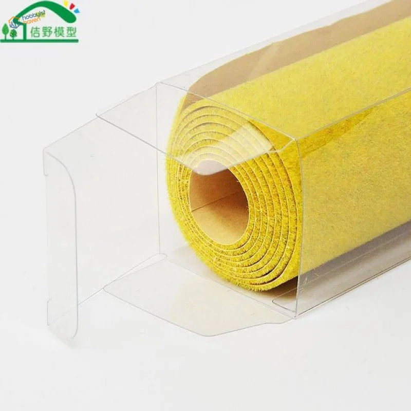 Vibrant yellow textured felt landscape grass mat in clear display case