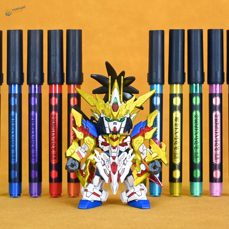 A vibrant gundam figure painted with lazy master metallic paint markers in gold white red blue and black in front of colorful pens