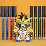 A vibrant gundam figure painted with lazy master metallic paint markers in gold white red blue and black in front of colorful pens