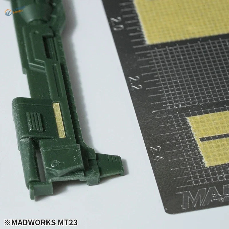 Dark green MadWorks masking tape cutting template part with gold accent