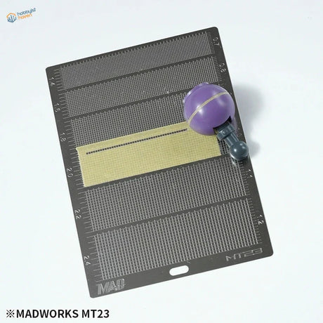 Purple spherical MadWorks masking tape cutting template tool on MT23 mat