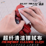 Microfiber cloth removing dust from red plastic robot in scale modeling
