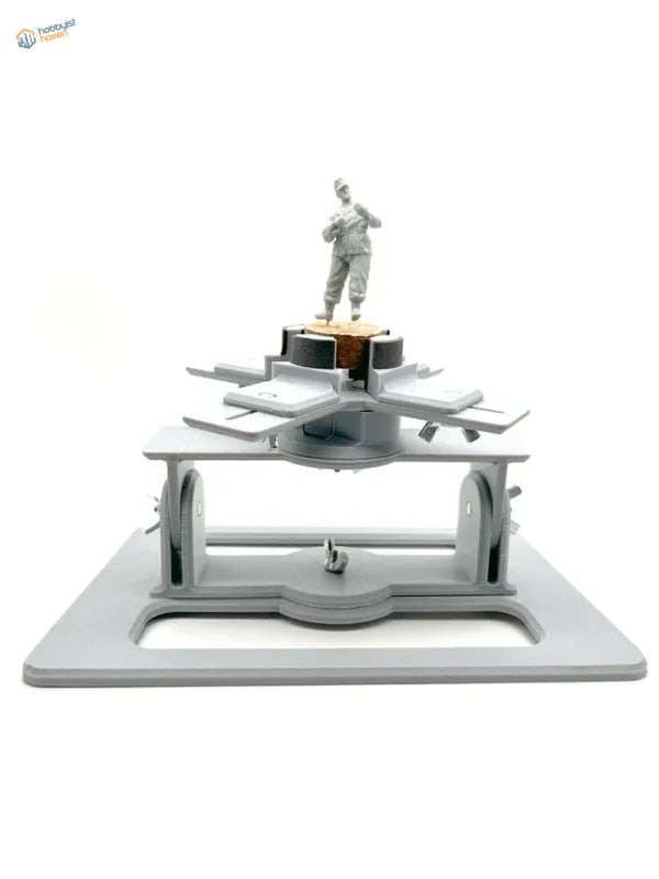 Gray plastic soldier on multi-level Model AFV Holder stand