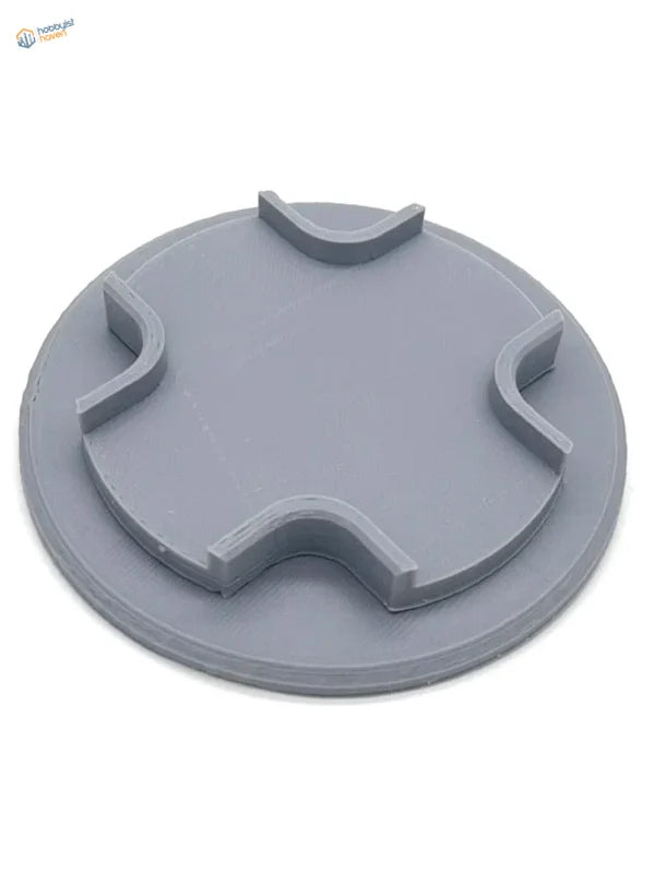 Gray circular plastic lid with notches for model aircraft holder