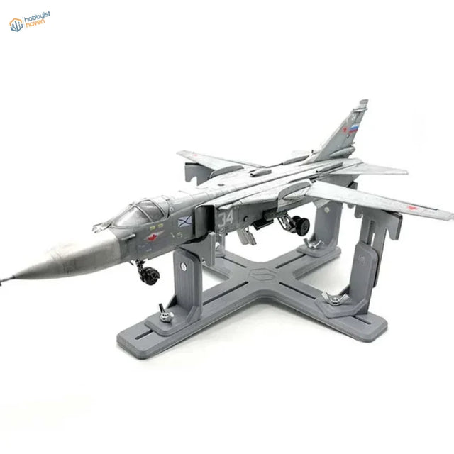 Gray Su-24 model aircraft on matching holder stand with markings