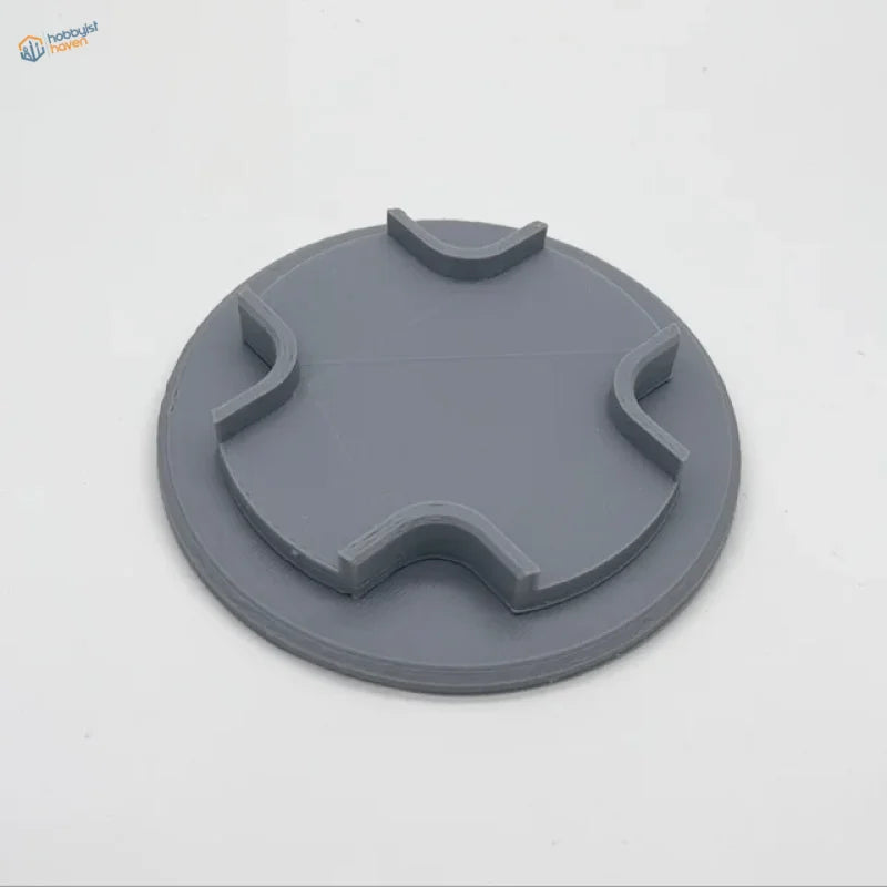 Gray circular plastic lid with notches for model aircraft holder