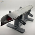 Gray metallic futuristic aircraft carrier model on ship holder stand