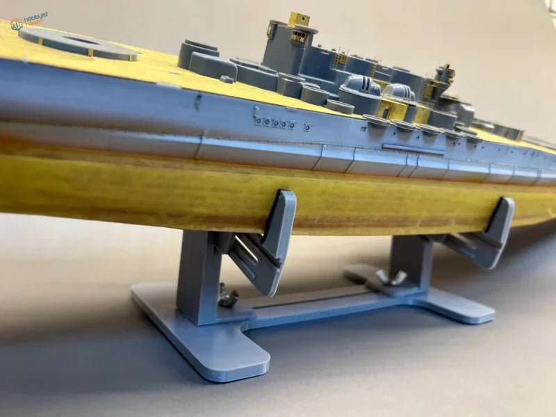Detailed yellow gray model submarine on model ship holder stand