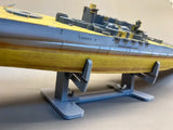Detailed yellow gray model submarine on model ship holder stand