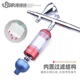 Chrome-finished movable moisture trap airbrush with red filter housing and blue nozzle