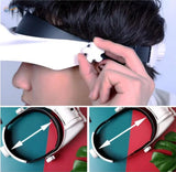 Multi-lens LED magnifier visor held in hand