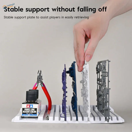White multifunctional sprue holder with ridged slots for tools and parts