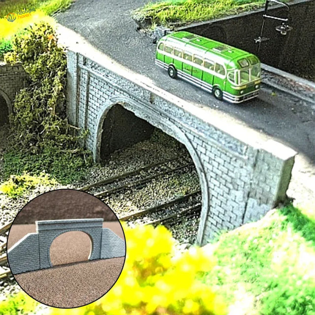 Green and white model bus on a n scale stone tunnel portal with arch opening for model railway scenery
