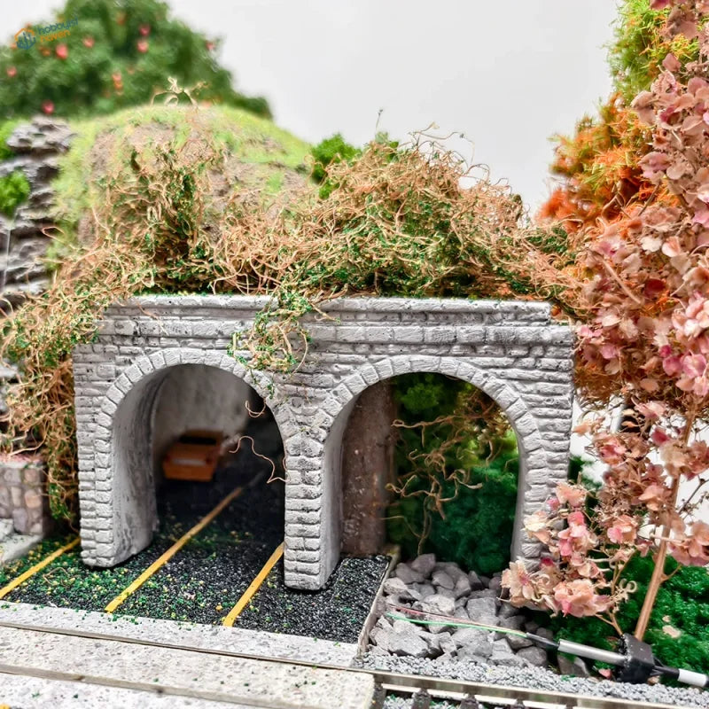 Gray stone tunnel portal with arch opening featuring realistic moss and vine detailing for n scale model railway scenery
