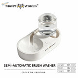 White plastic semi-automatic brush cleaning station with clear glass water reservoir for efficient brush cleaning