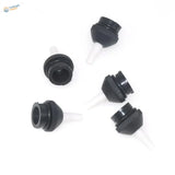 Black plastic bottle caps with white tapered spouts on powerful desoldering pump
