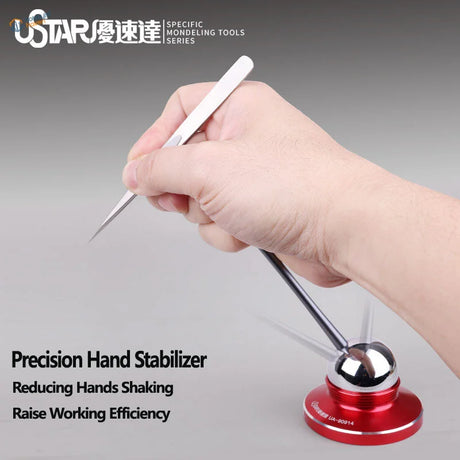 Precision hand stabilizer with red metallic base and silver spherical stabilizer holding white precision hand modeling tool