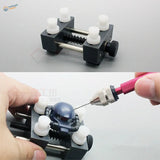 Precision mini vise with black and white adjustable clamps for watch repair
