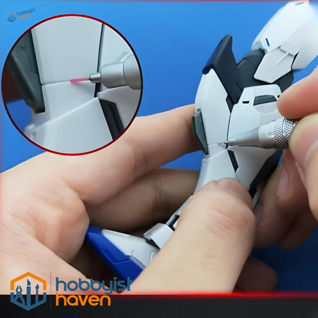 Detailing white black Gundam model with precision sanding stone pen
