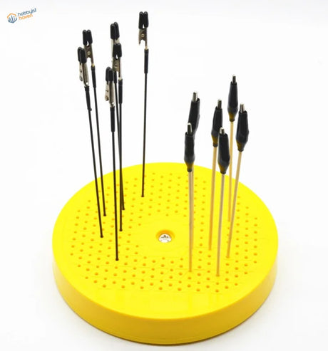 Rotary painting turntable with yellow stand and black alligator clips