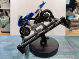 Blue and white 1/18 motorcycle model on rotating holder stand