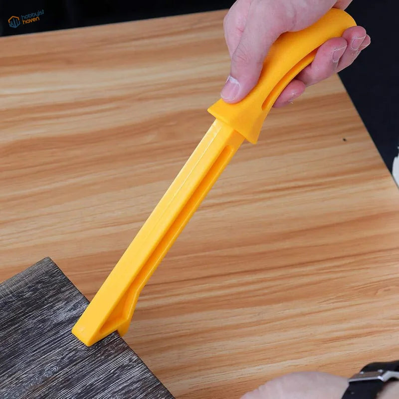 Yellow plastic floor scraper push stick with ergonomic handle and ridged blade