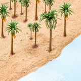 Scale model palm trees with green plastic fronds, brown trunks, orange flowers