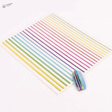 Rainbow stripe stickers on glittery blue nail with decals on white sheet