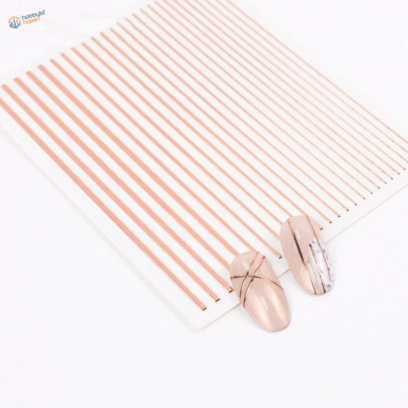 Rose gold striped nail art decals on white sheet with applied nails