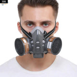 Gray face dust mask with black straps and brown filter canisters