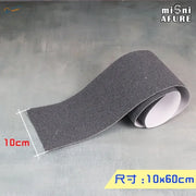 Dark gray textured Simulated Asphalt Stickers grip tape roll with white backing